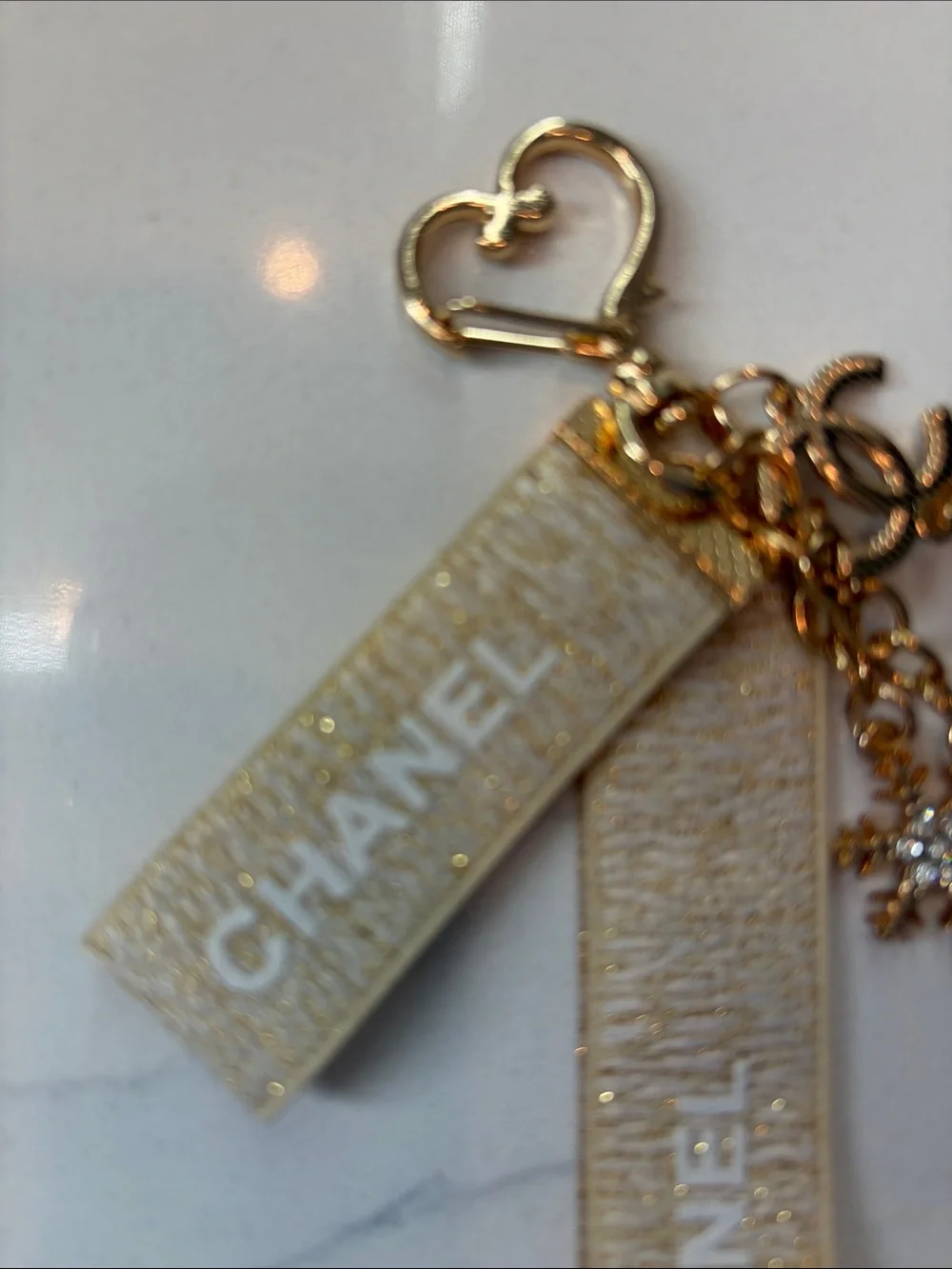 Beige and Gold Logo Strap Keychain with Charms